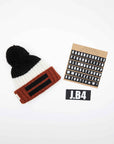 SPEAKING BEANIE POMPON ALPACA NERO-PANNA-ARANCIONE
